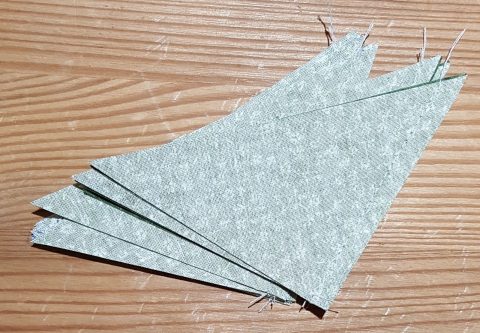 Star side of sewn triangle pieces for Ohio Star quilt block