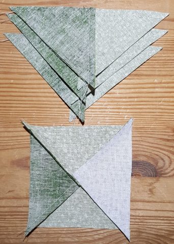 Press seam on sewn triangle pieces for Ohio Star quilt block