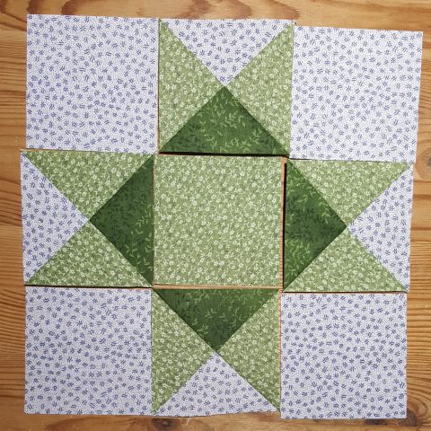 Arrange the sewn triangles to form Ohio Star quilt block